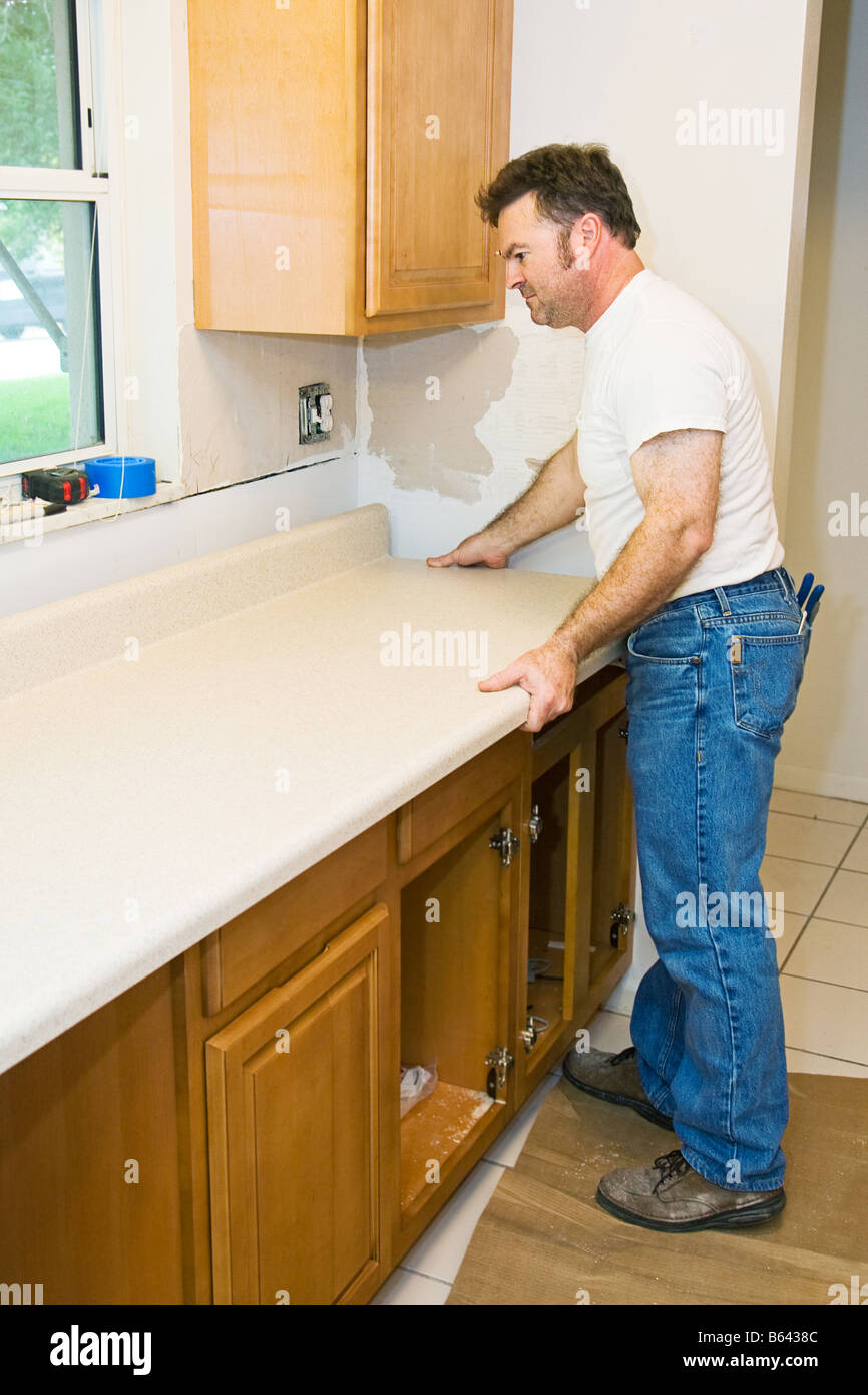 Contractor remodeling kitchen installing and counter top Stock