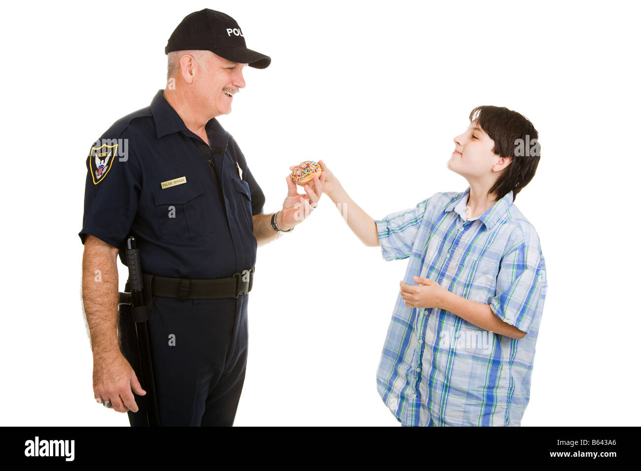 Adolescent boy giving a donut to a police officer Isolated on white Stock Photo