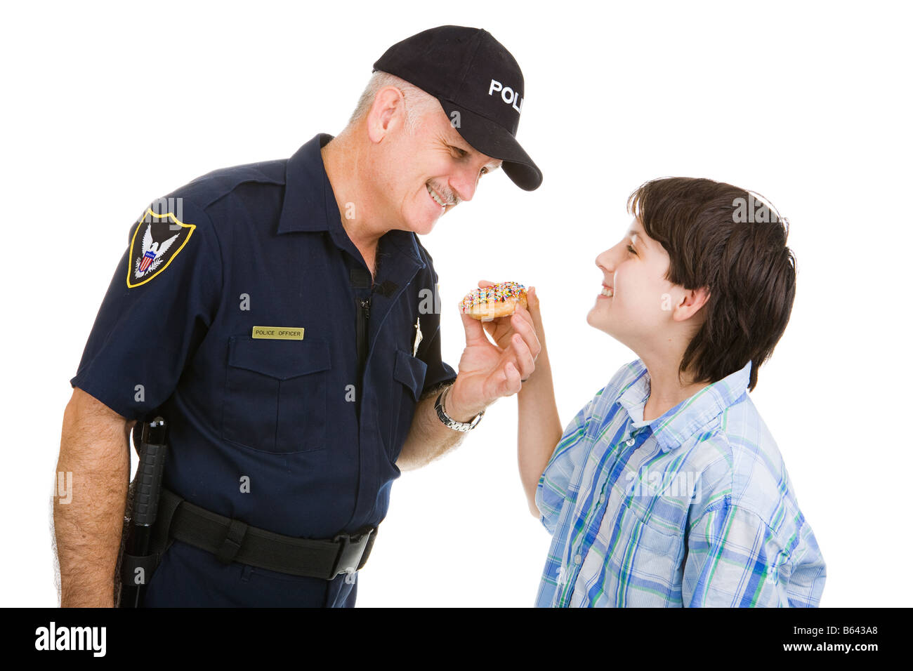 Adolescent boy giving a donut to a friendly police officer Isolated on white Stock Photo