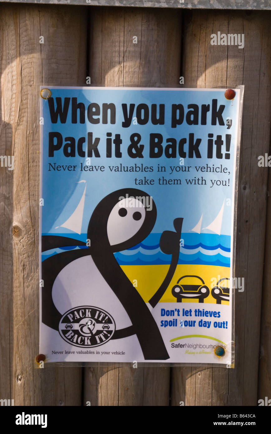 Sign warning of car theft thieves operating in uk car park saying don't leave valuables in your vehicle Stock Photo