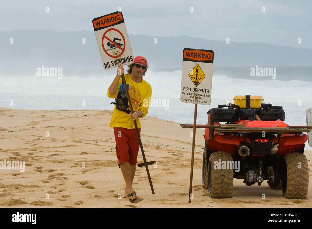 Lifeguard posting hazard condition signs on beach Stock Photo Alamy