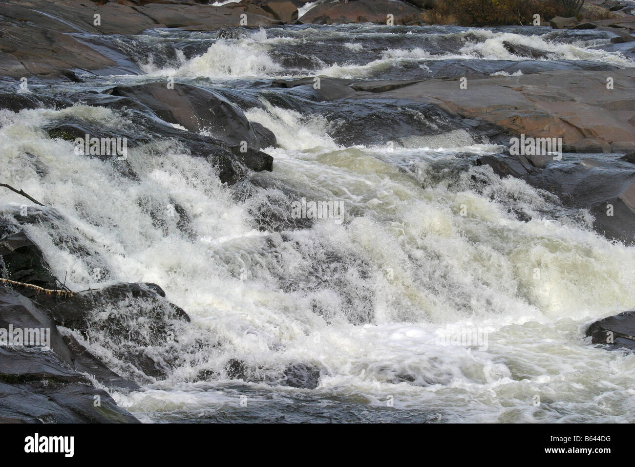 river rapids cascading over rocks Stock Photo