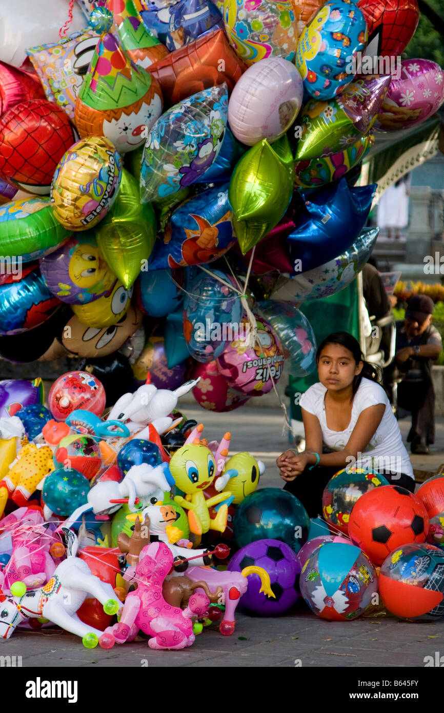 Oaxaca, Mexico. Day of the Dead. Indian Girl Balloon Vendor in Zocalo (Town Square, Plaza de Armas). Stock Photo