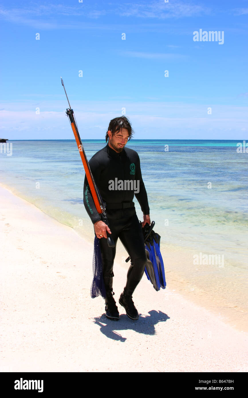 a diver walking along beach on east wallabi island in the abrolhos islands Stock Photo