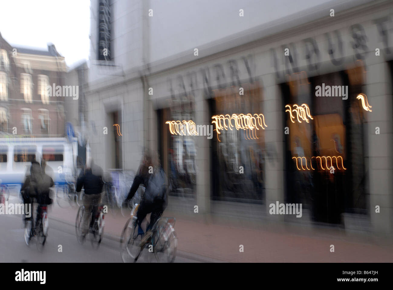 A street in Amsterdam - blurred cyclists Stock Photo - Alamy