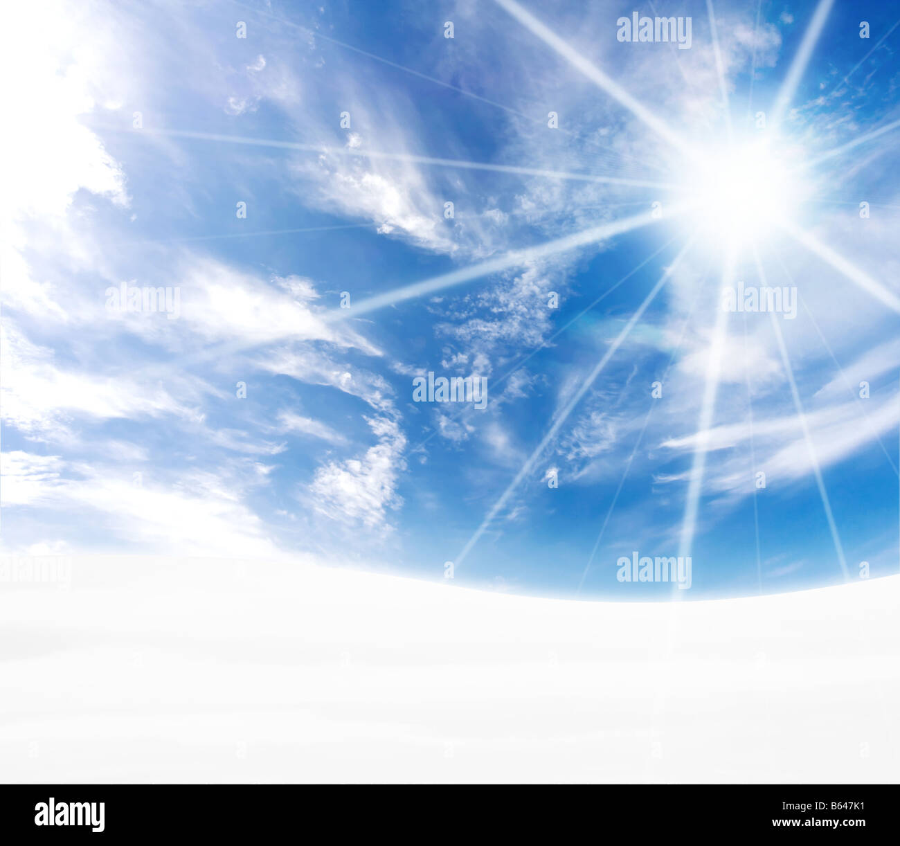 A simple tranquil beautiful S curved horizon with blue sky and winter snow Freezing feel with sun flare Stock Photo