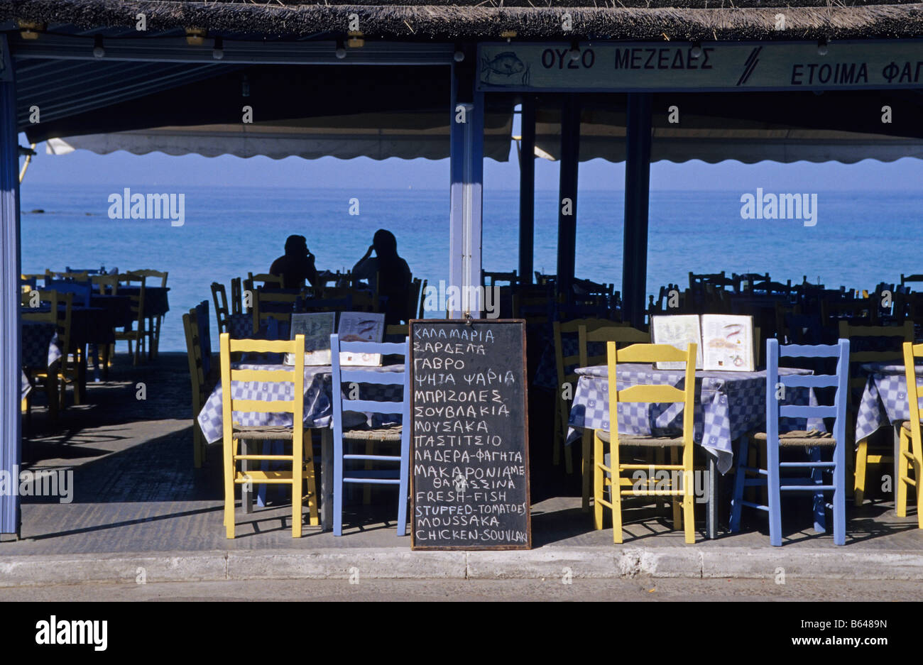 Blackboard menu in at an ocean front Greek Taverna, Aegina Island, Greece Stock Photo