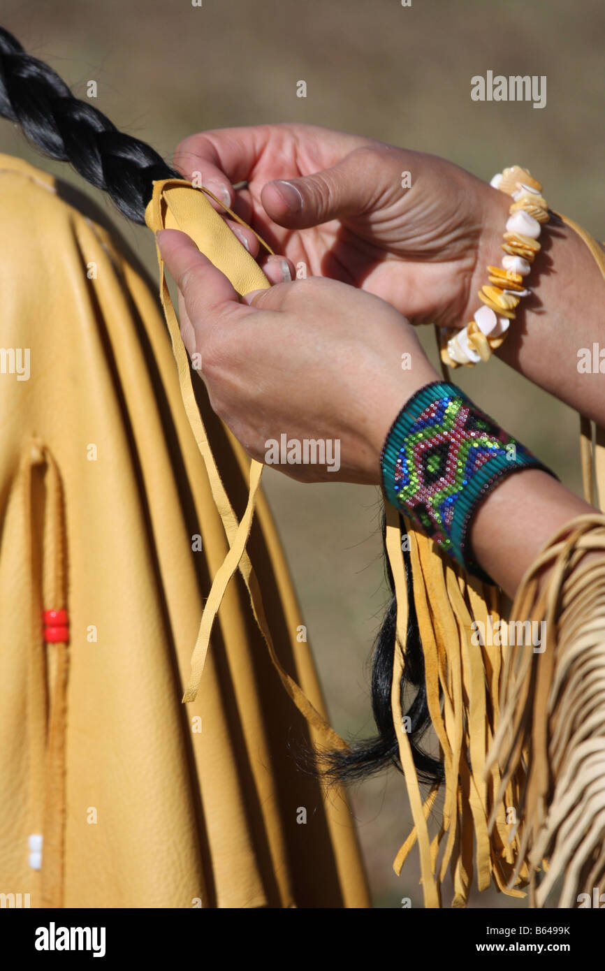 Two Native American Indian women with fringe leather dress braiding