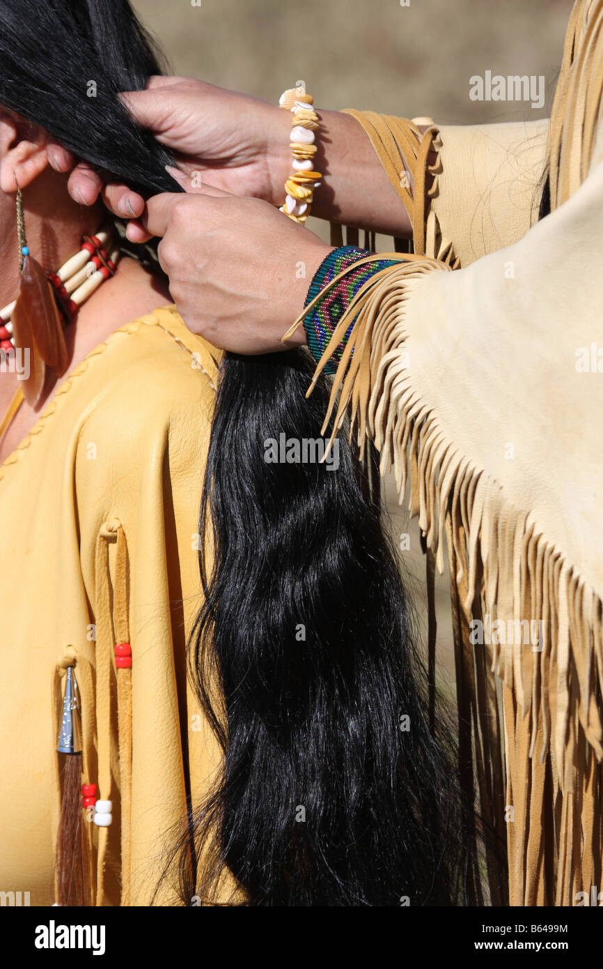 Two Native American Indian women with fringe leather dress braiding