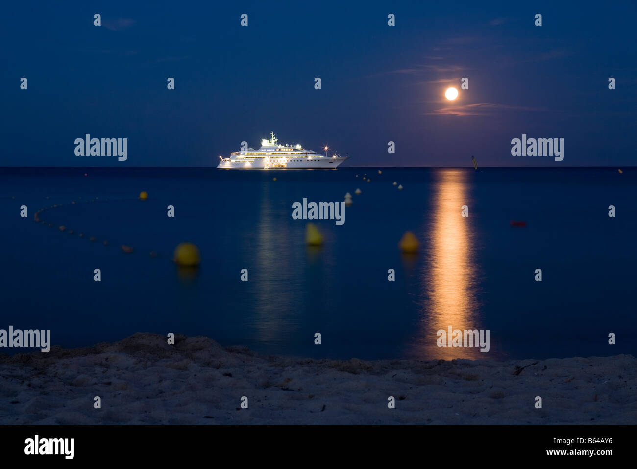 Lady Moura yacht belonging to Nasser Al Rashid and the full moon in front of Pampelonne beach, St Tropez, France Stock Photo