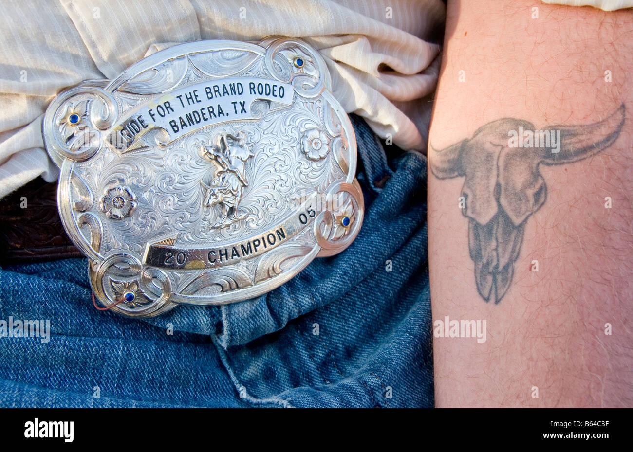 Texas Hill Country, Dixie Dude Ranch, rodeo cowboy's belt buckle and tattoo Stock Photo