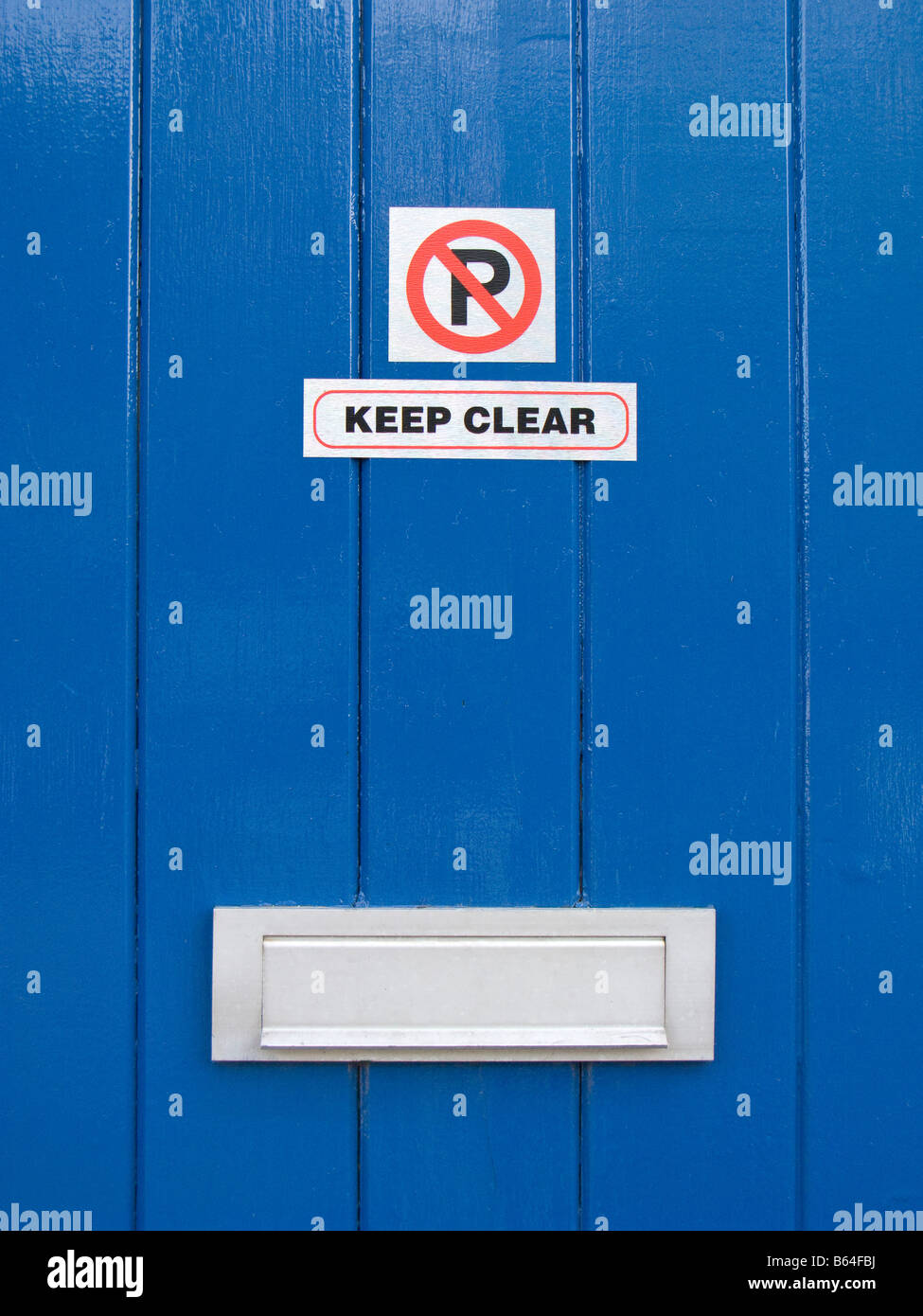 "No Parking" and "Keep Clear" Sign on Blue Painted Door Stock Photo Alamy