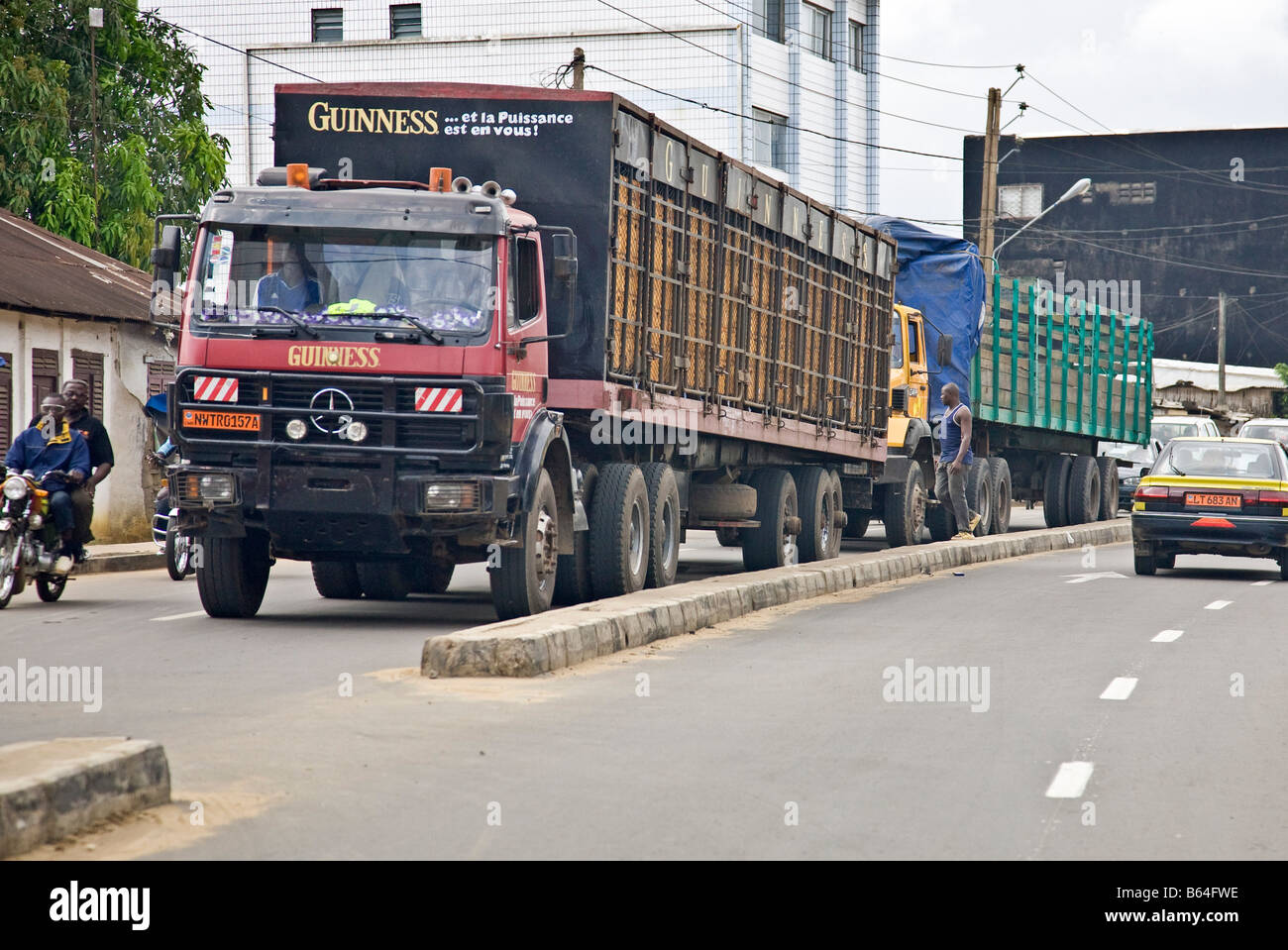 Heavy goods vehicle delivering Guiness in traffic, Douala, Cameroon, Africa Stock Photo
