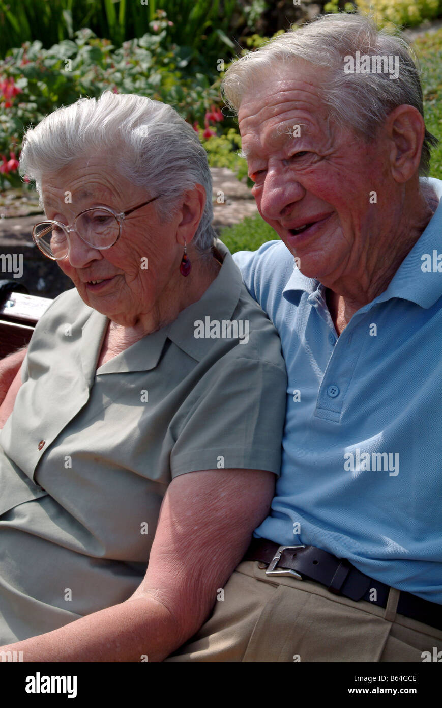 Elderly couple sitting and relaxing outdoors together Stock Photo - Alamy