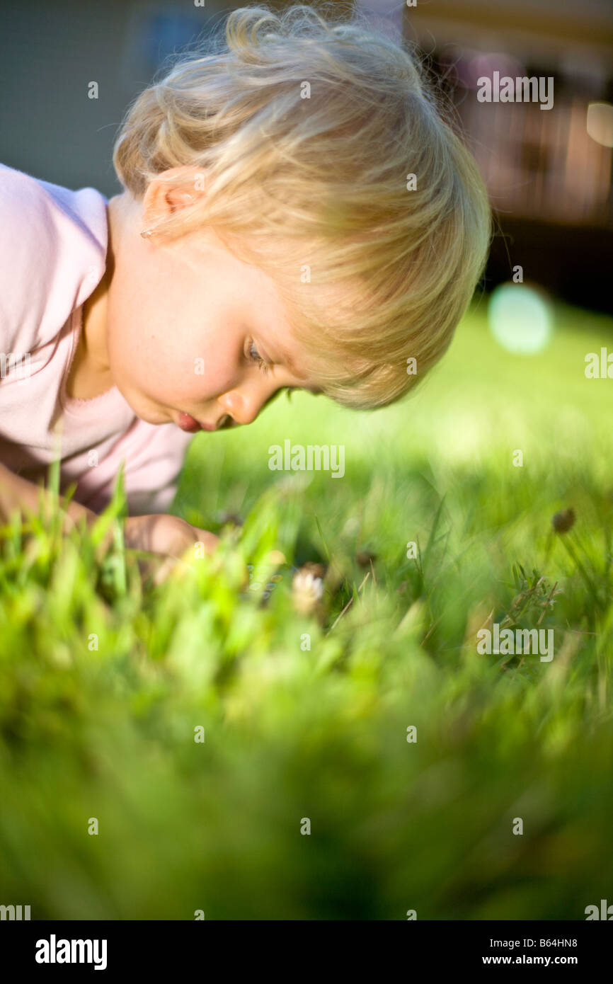 Baby girl playing in the grass Stock Photo - Alamy