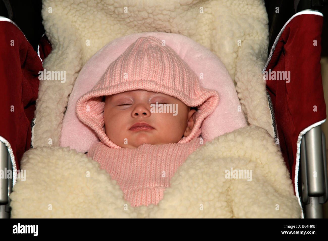 Baby girl wrapped in warm clothes and laying in her buggy Stock Photo -  Alamy