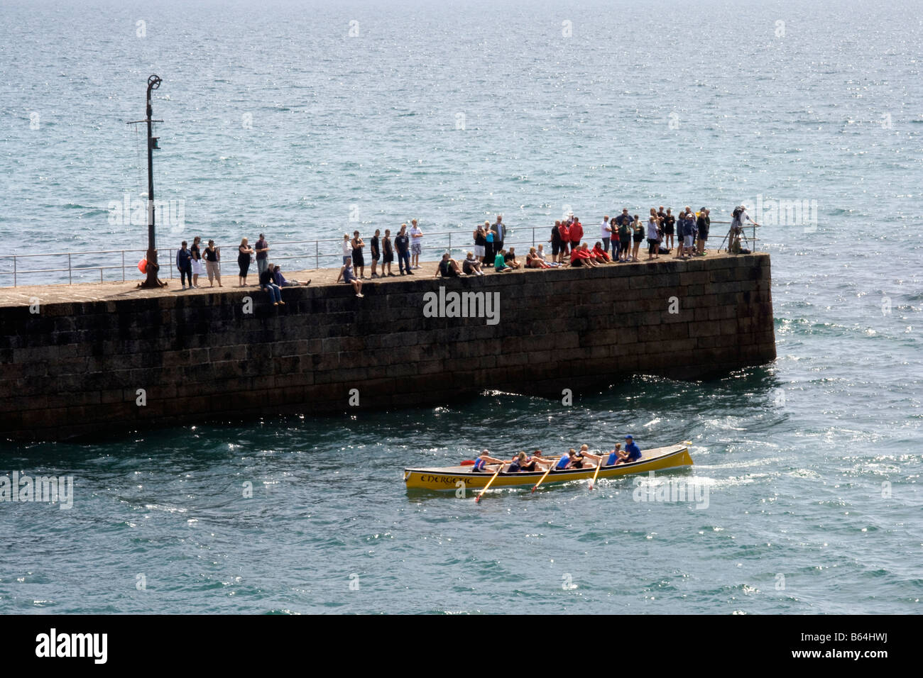 A Cornish pilot gig leaves the harbour of Porthleven during a gig-race, Cornwall, England, Great Britain, United Kingdom. Stock Photo