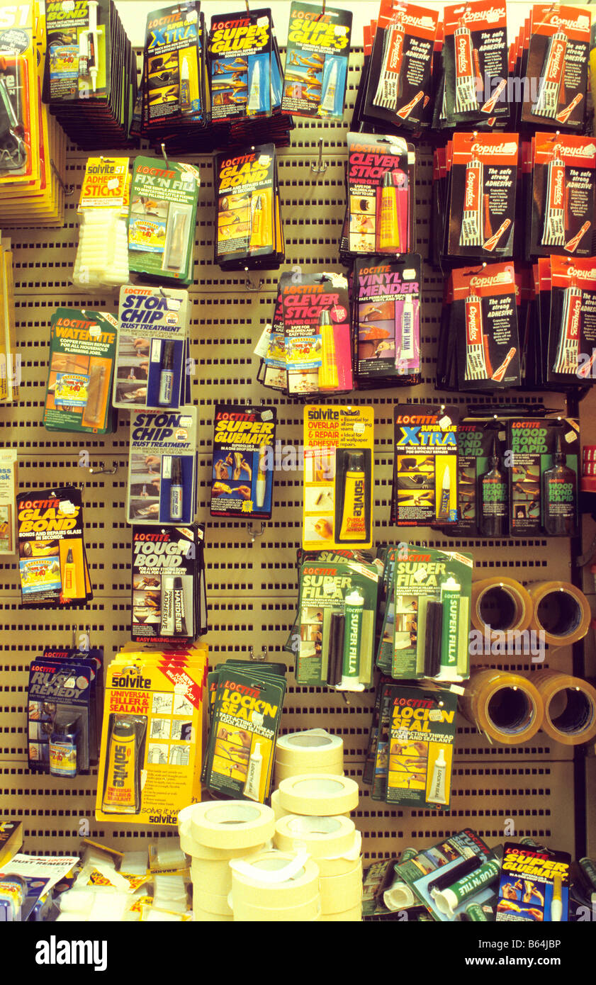 Retail display of glues on pegboard racks Stock Photo - Alamy
