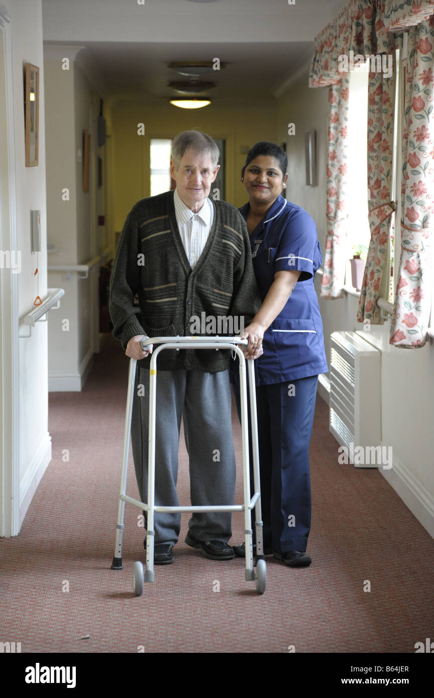 Elderly gentleman and care worker at nursing home for people with
