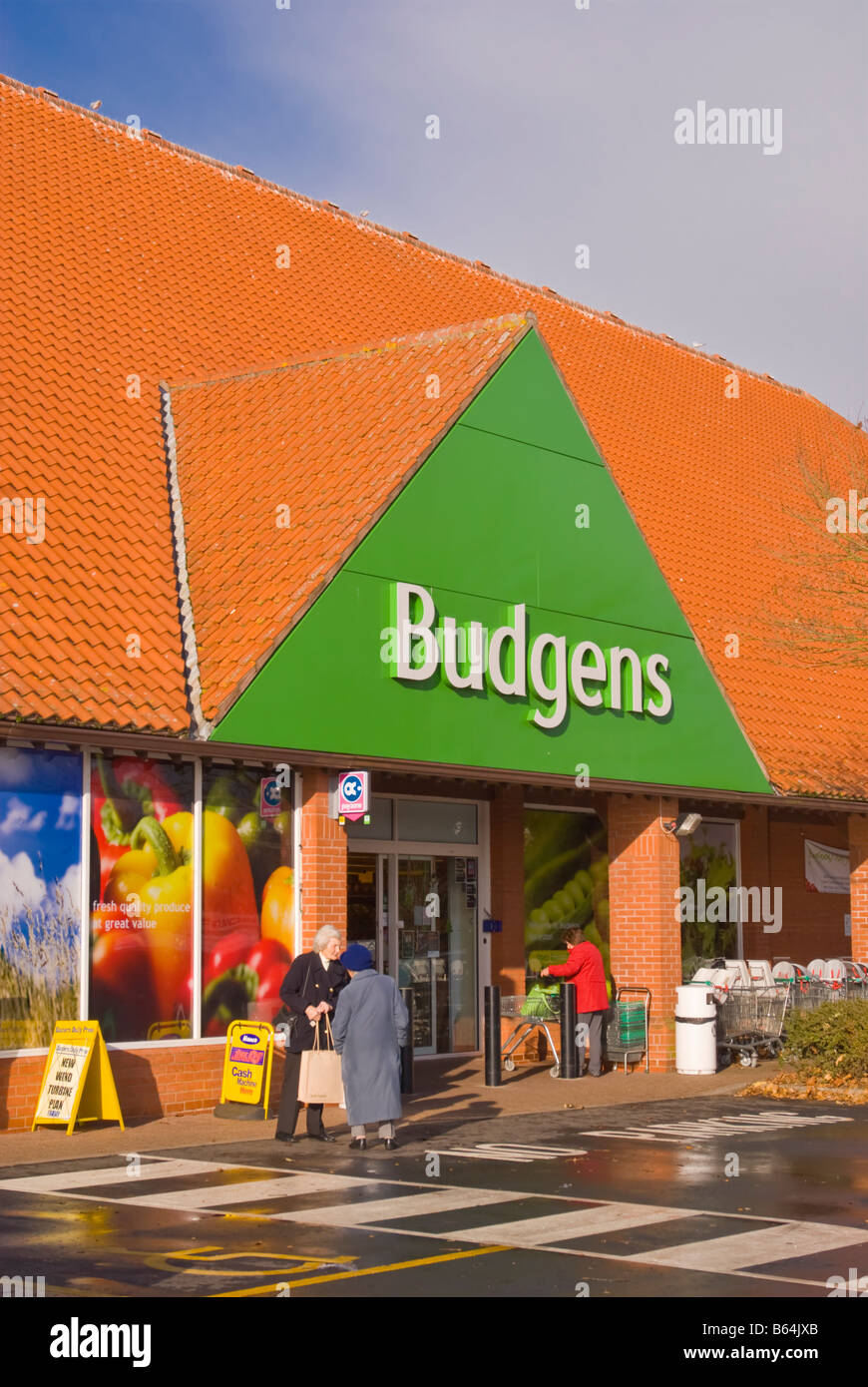 Budgens supermarket superstore shop store selling groceries etc. with customers outside in Harleston,Norfolk,Uk Stock Photo