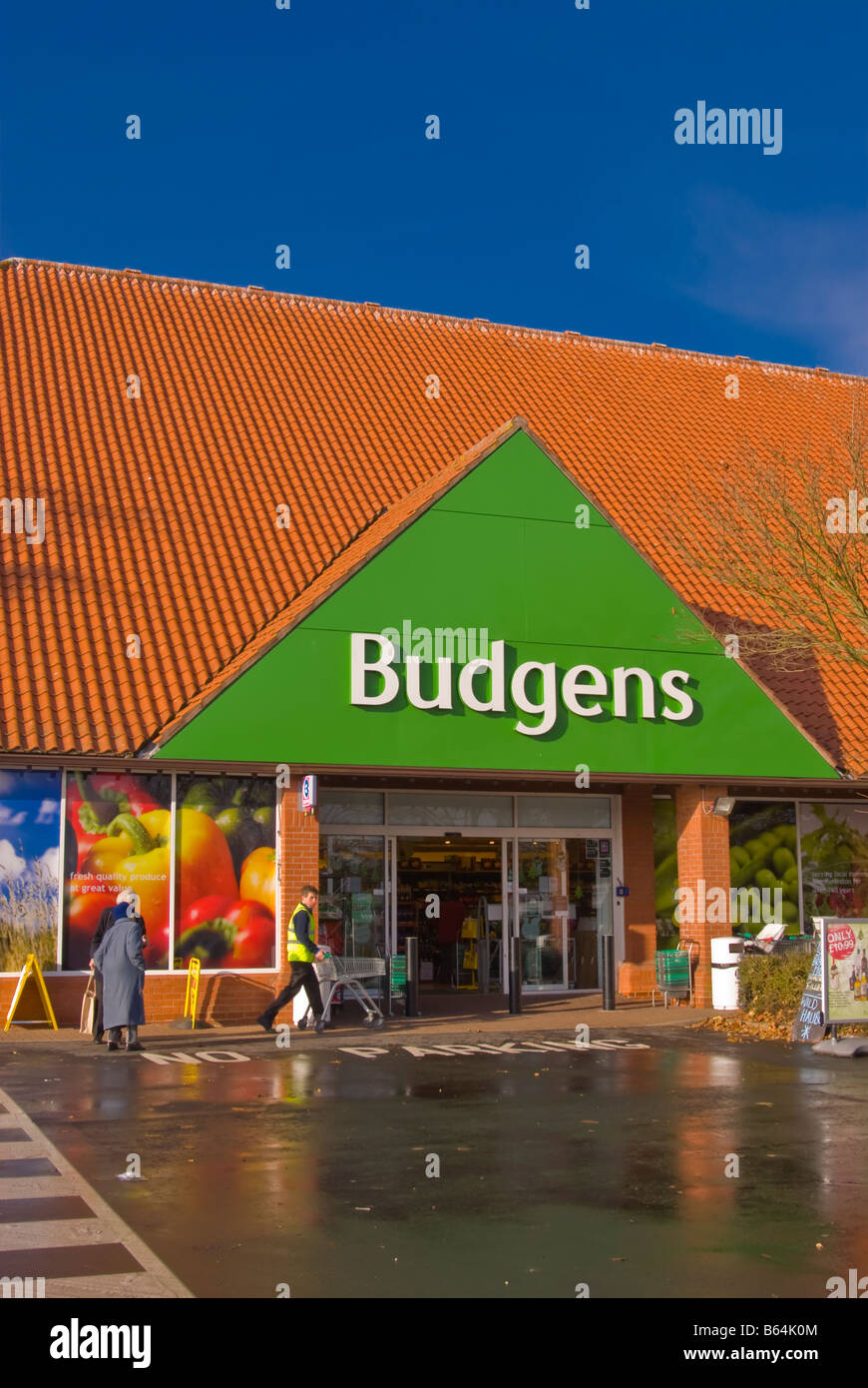 Budgens supermarket superstore shop store selling groceries etc. with customers outside in Harleston,Norfolk,Uk Stock Photo