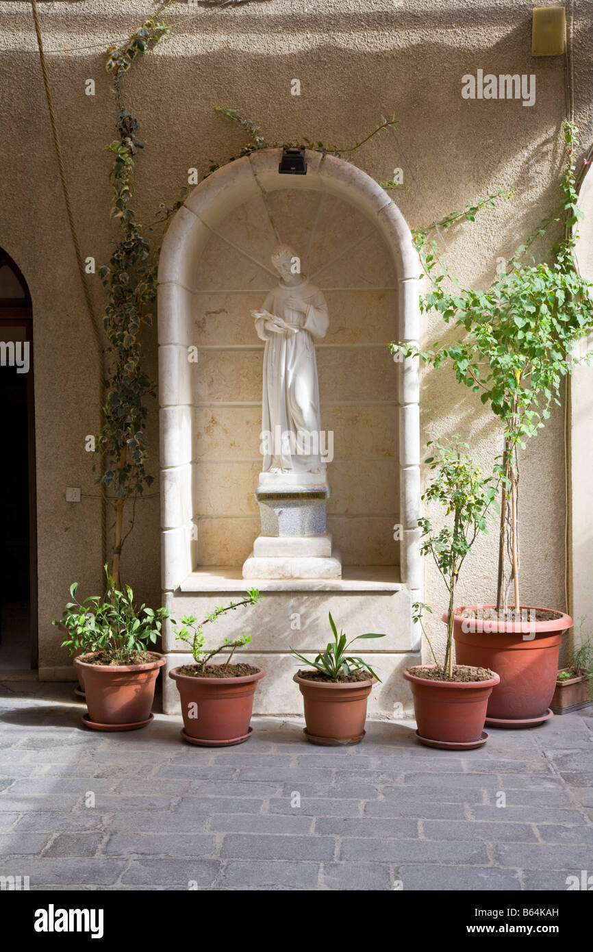 Statue of St Francis of Assisi in the courty yard of St Ananias . Old