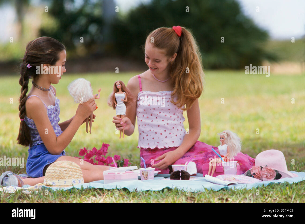 Young girls playing  barbie dolls together, Stock Photo