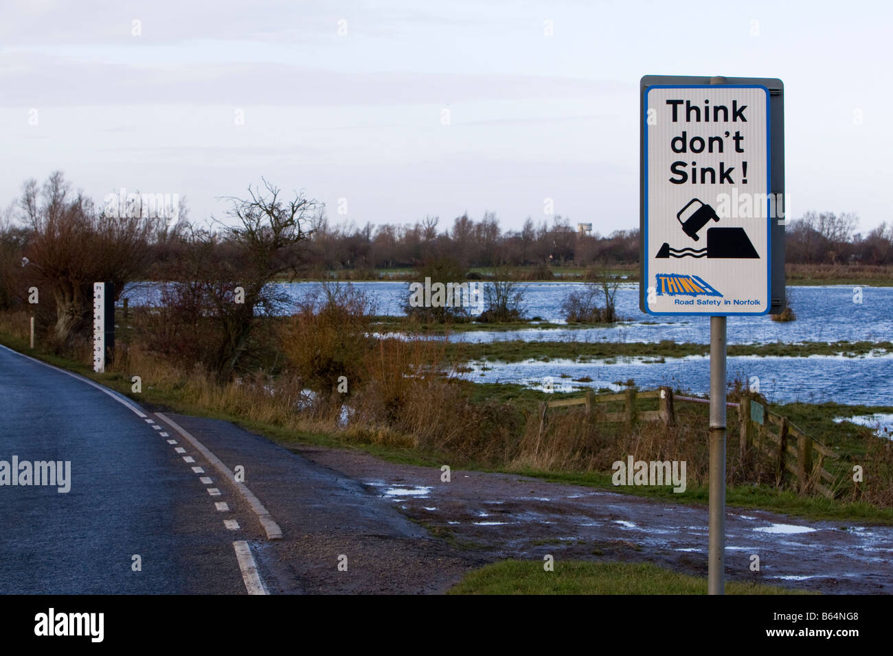 'Think don't Sink' sign warning of soft verges and flooding on B1100 across the Hundred Foot Washes near Welney, Norfolk UK Stock Photo