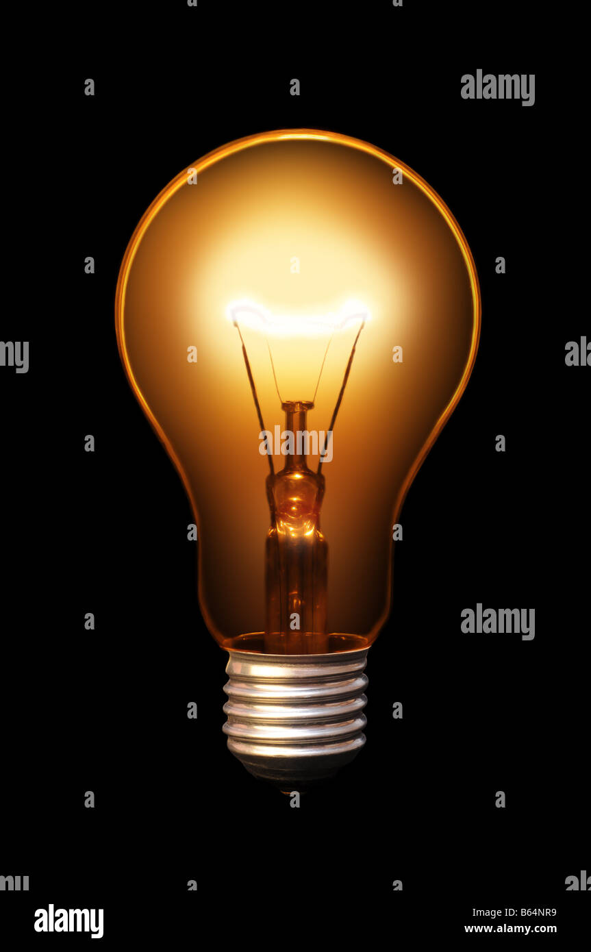 Classical old style bulb shining on black background. Stock Photo