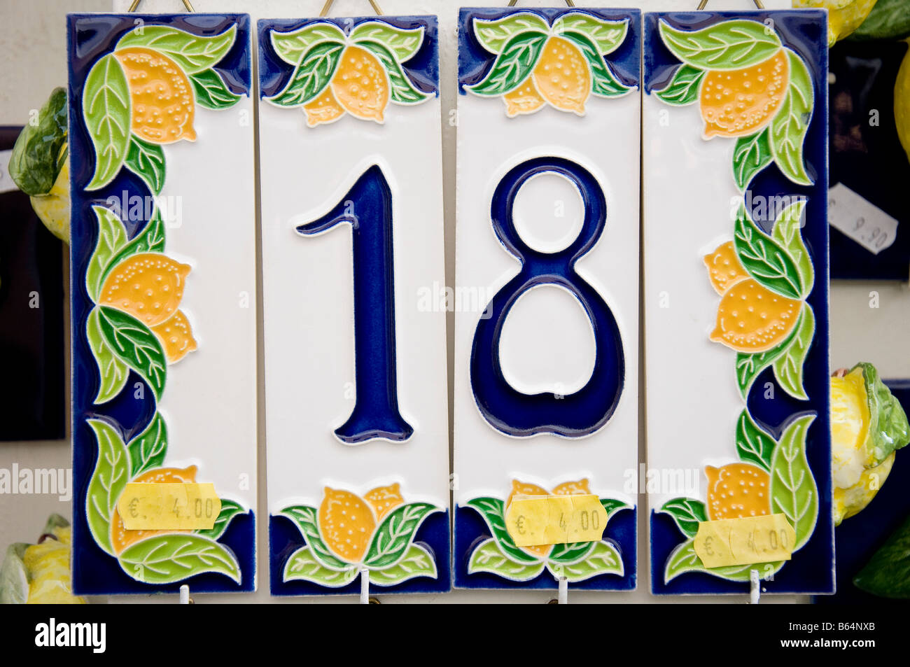 House number 18 and lemons on a ceramic tile for sale with price labels Limone sul Garda Lake Garda Italy Stock Photo