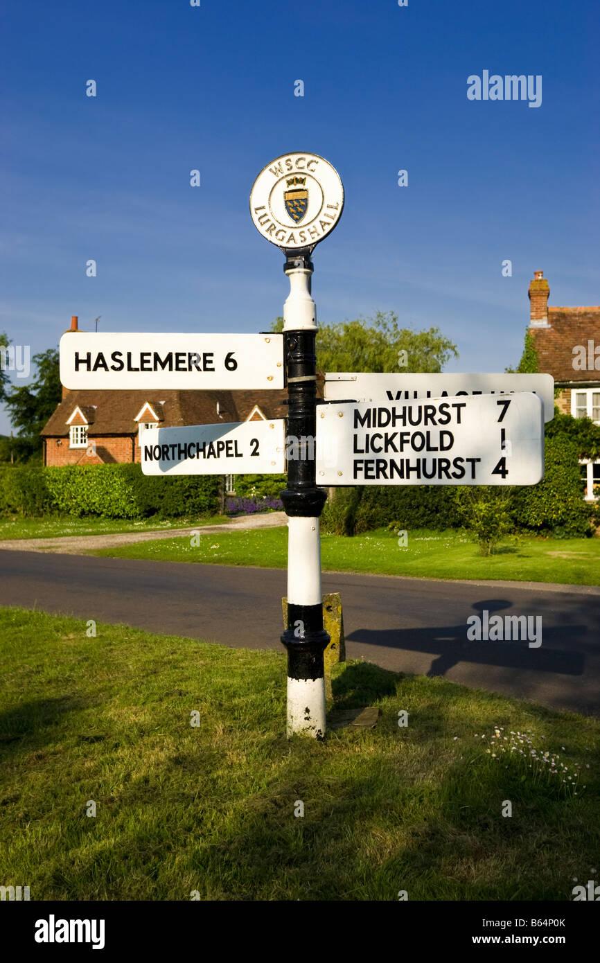Old signpost with directions in miles on the village green at Lurgashall, West Sussex, England, UK Stock Photo
