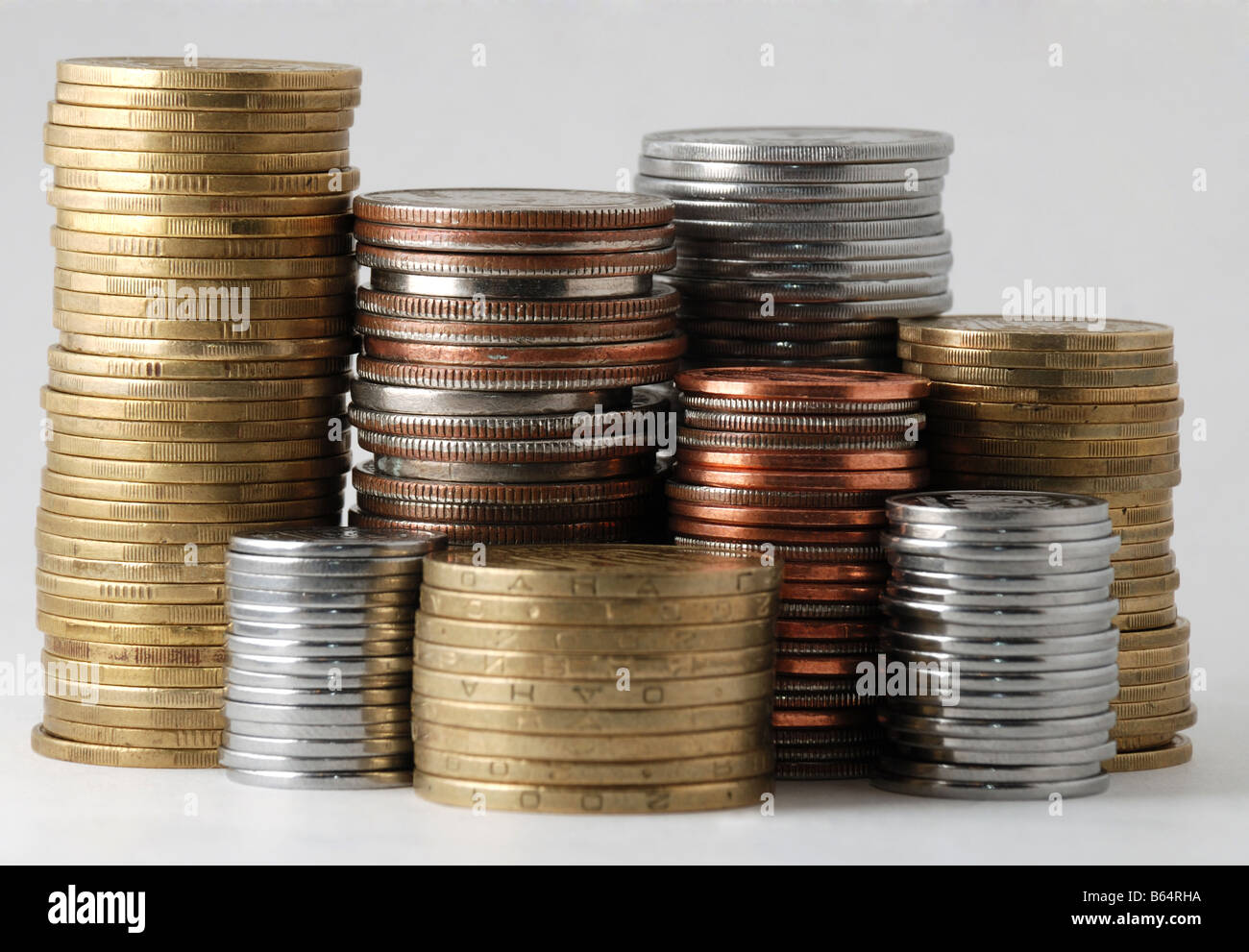 The piles of coins isolated on white background Stock Photo - Alamy
