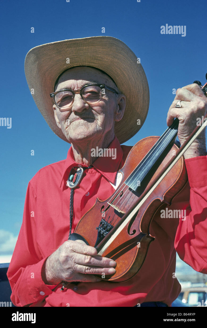 An elderly cowboy poses with his fiddle at the Old Time Fiddler s Contest in Truth or Consequences New Mexico Stock Photo