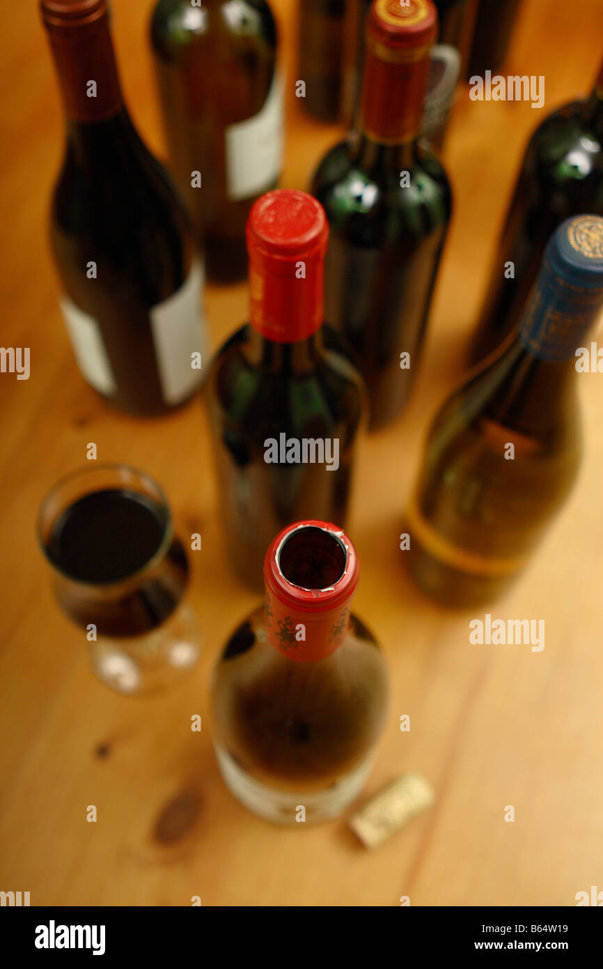 Open Red Wine Bottle Cork And Wine Glass With Many Other Unopened
