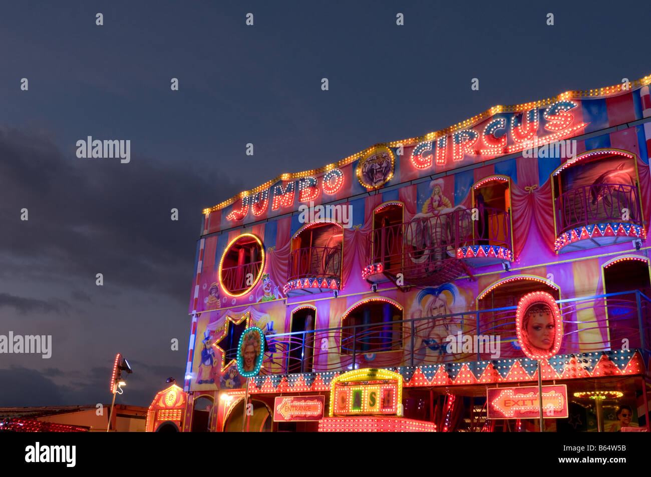 brightly lit fairground ride at dusk twilight UK Stock Photo