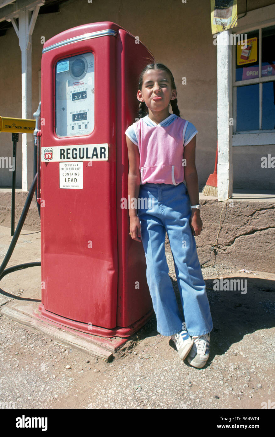 A little hispanic girl in the Pecos River town of San Jose on the Santa Fe Trail near her father