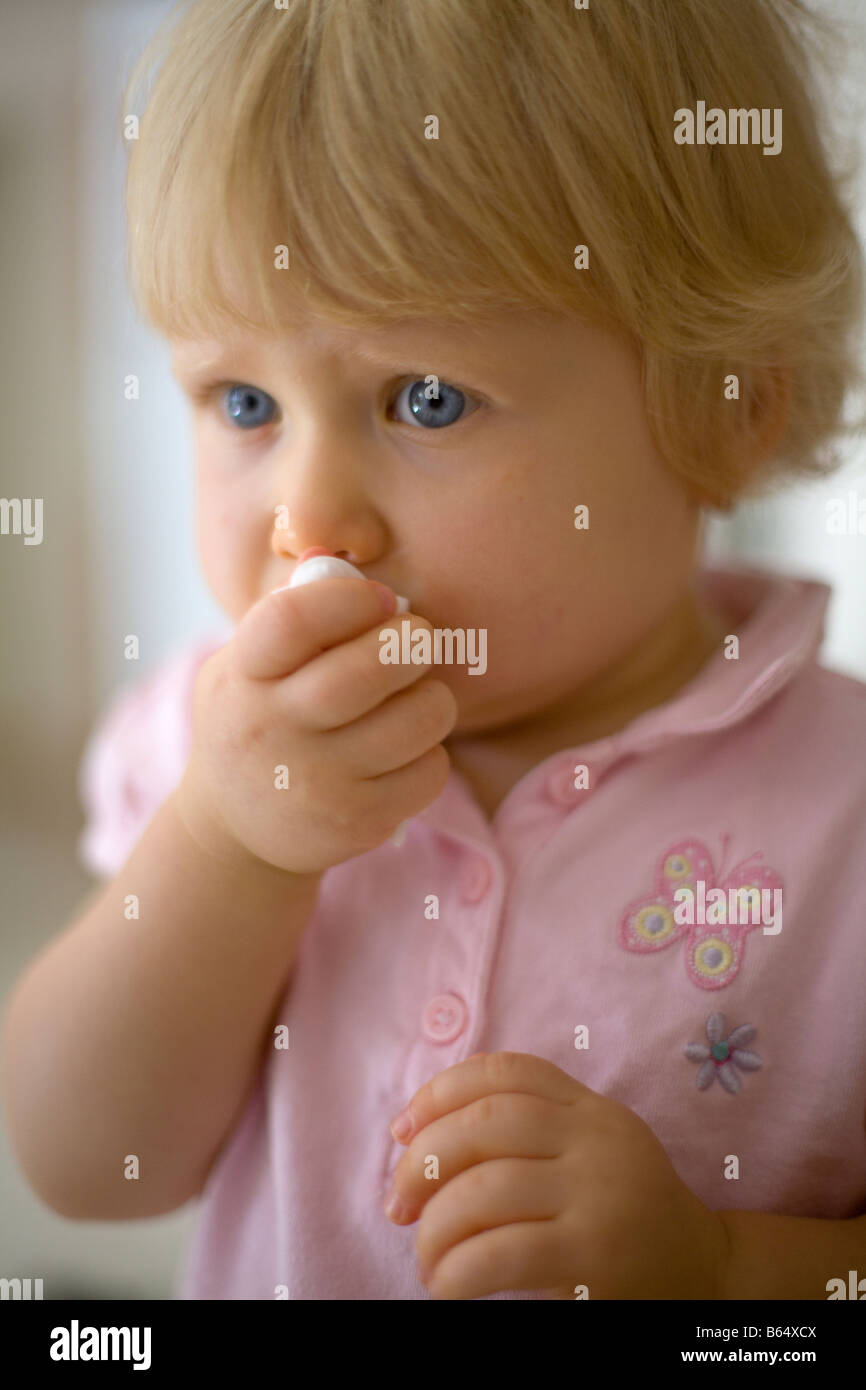 Baby Girl wiping face Stock Photo Alamy