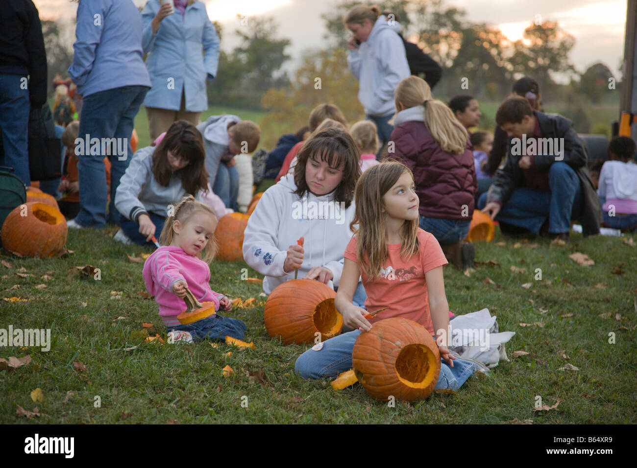 Families carve pumpkins at the 2008 Shenandoah Valley Hot Air Balloon and Wine Festival in Millwood, Virginia Stock Photo