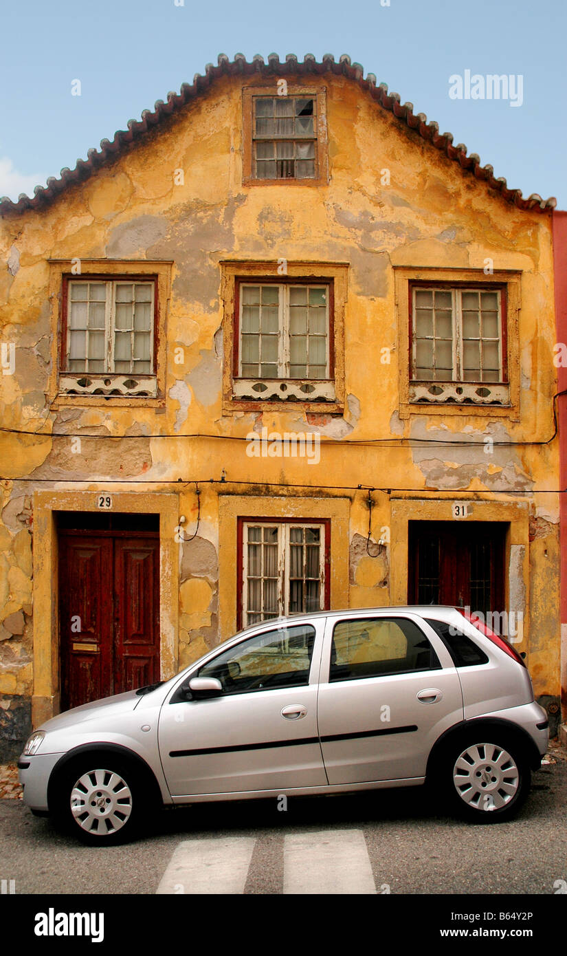 A car parked outside old  housing property in Portugal. Stock Photo