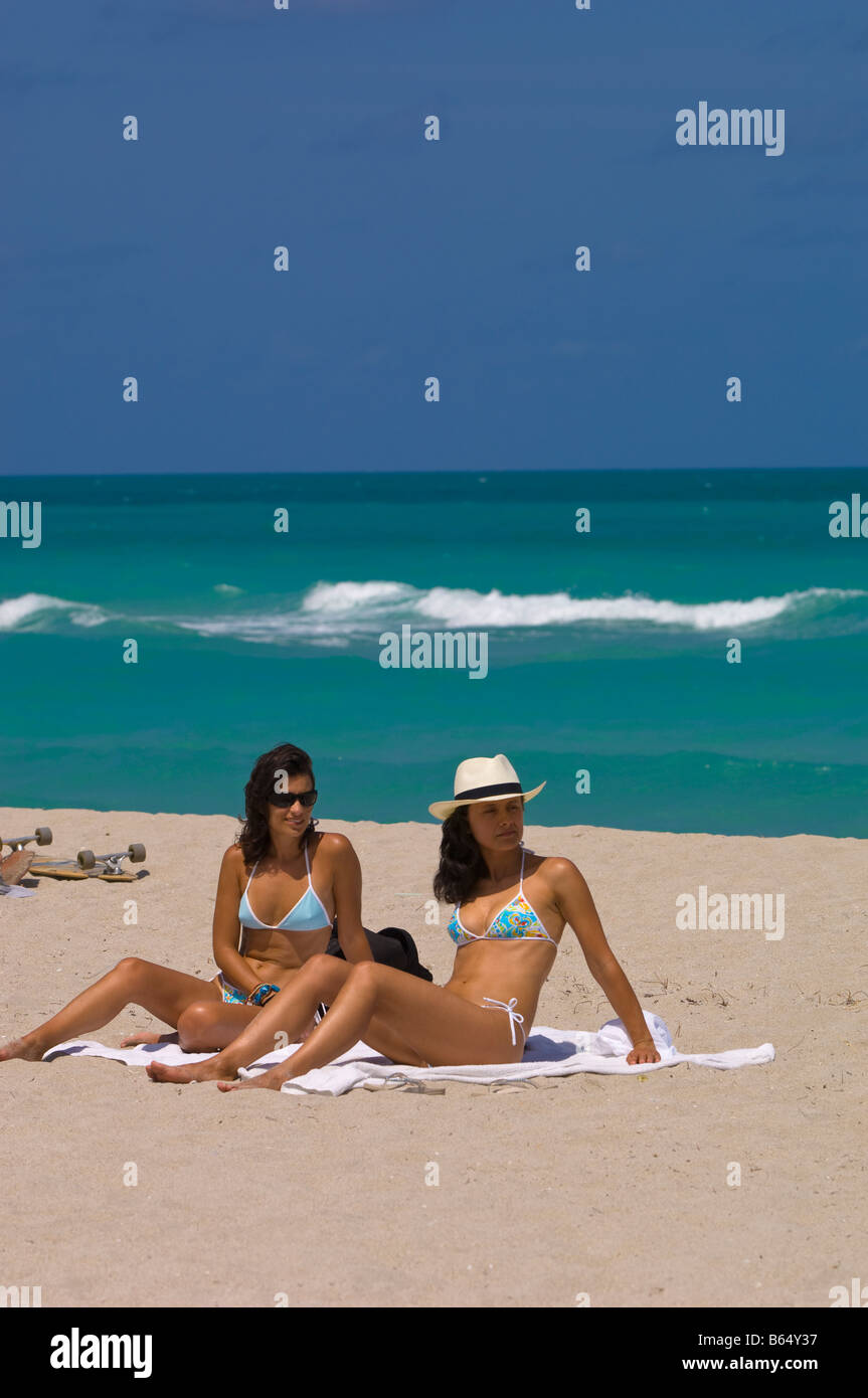 Two young girls relaxing having good time on a beach South Beach USA Photo - Alamy