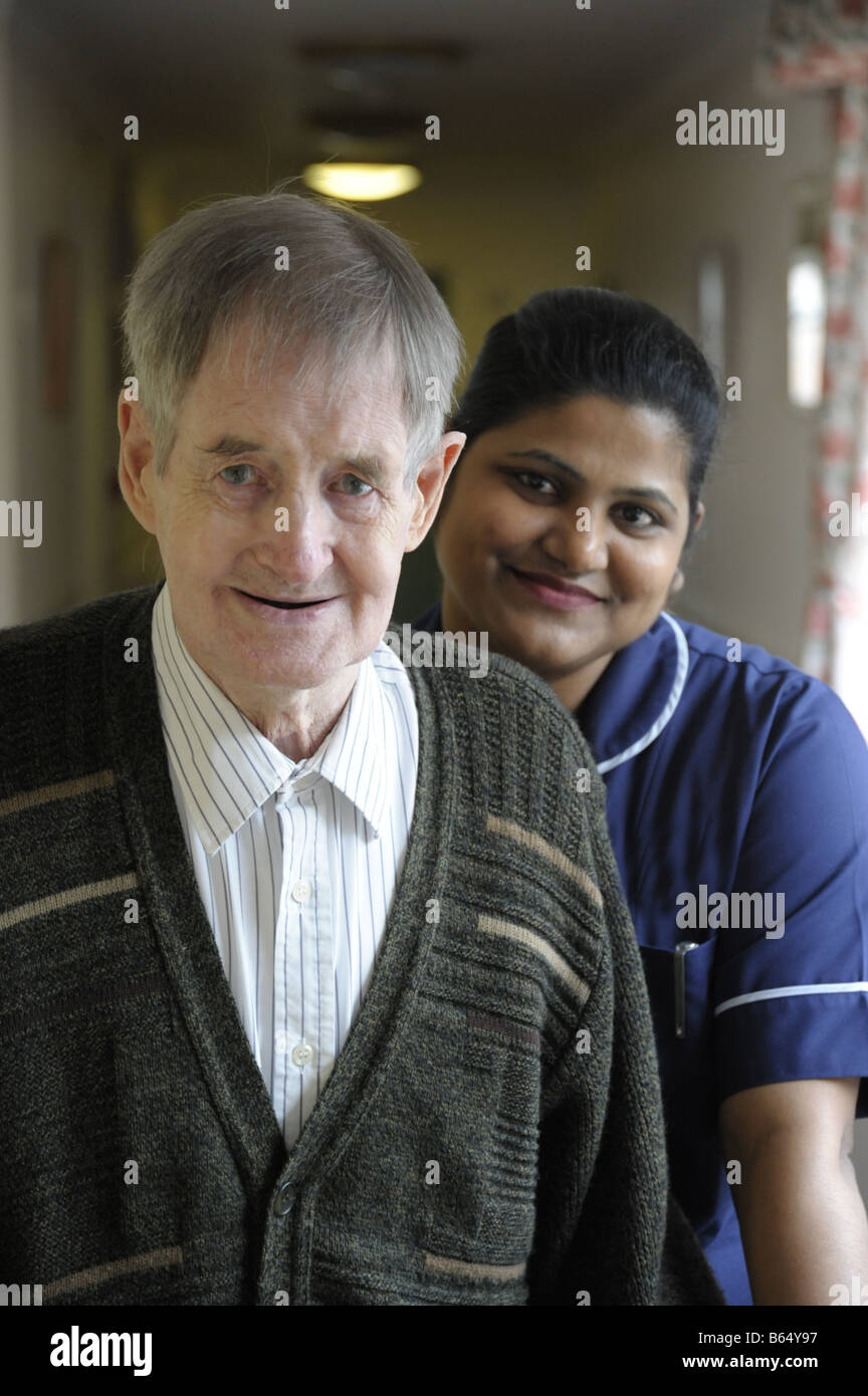 Senior man with nurse in background Stock Photo - Alamy