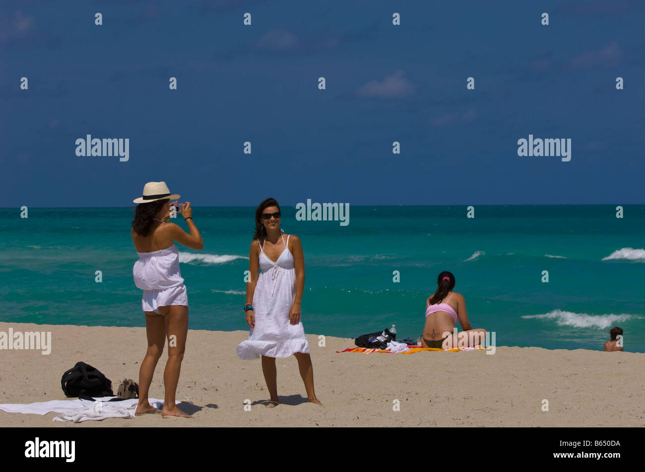 Two young girls relaxing having good time on a beach South Beach USA Photo - Alamy