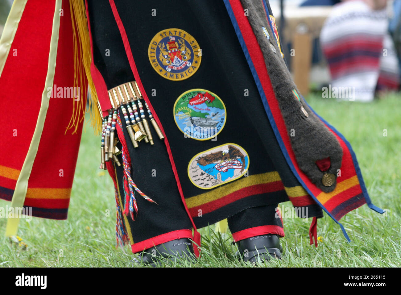 A Native American sports U.S. military badges sewn onto his traditional