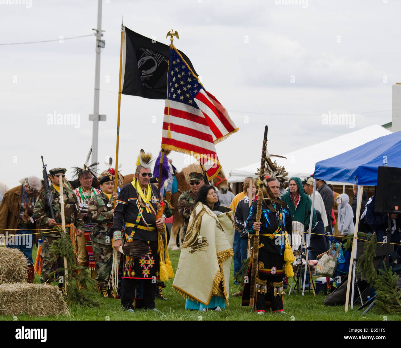 Native Americans at the Healing Horse Spirit PowWow in Mt. Airy, Maryland carry an American flag POW-MIA flag.  They standy read Stock Photo