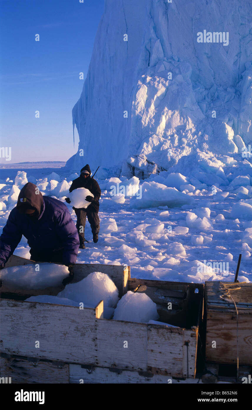 Inuit hunters collecting drinking water from a iceberg on Lancaster sound, Canada Stock Photo