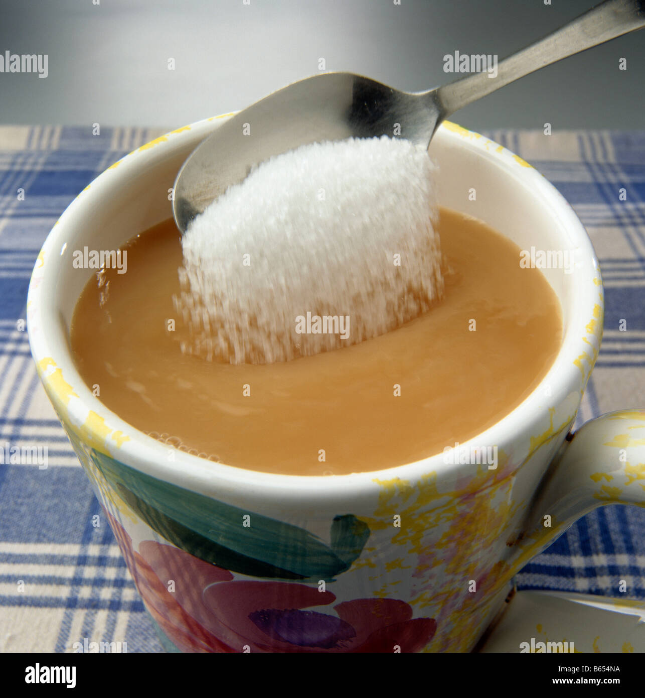 Adding a spoonful of sugar to a drink Stock Photo Alamy
