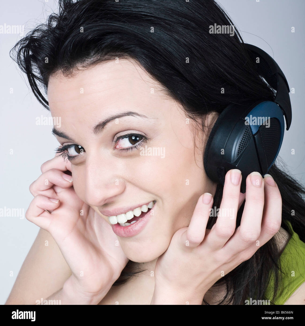portrait of a young woman listening music on isolated background Stock ...
