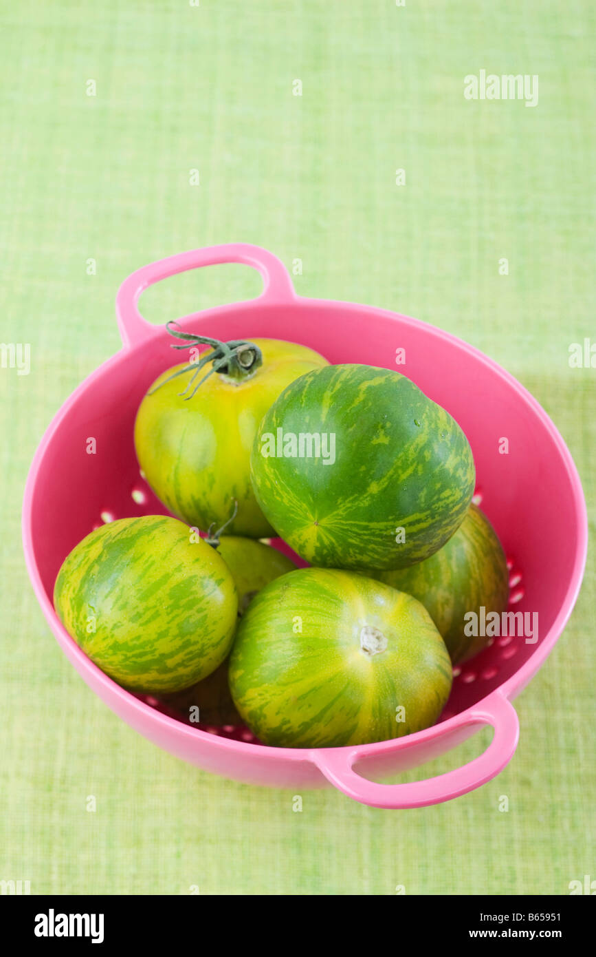 Zebra tomatoes in pink colander Stock Photo Alamy