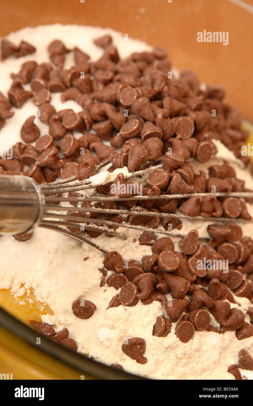 Making chocolate and banana muffins with flour in mixing bowl home baking cooking Stock Photo