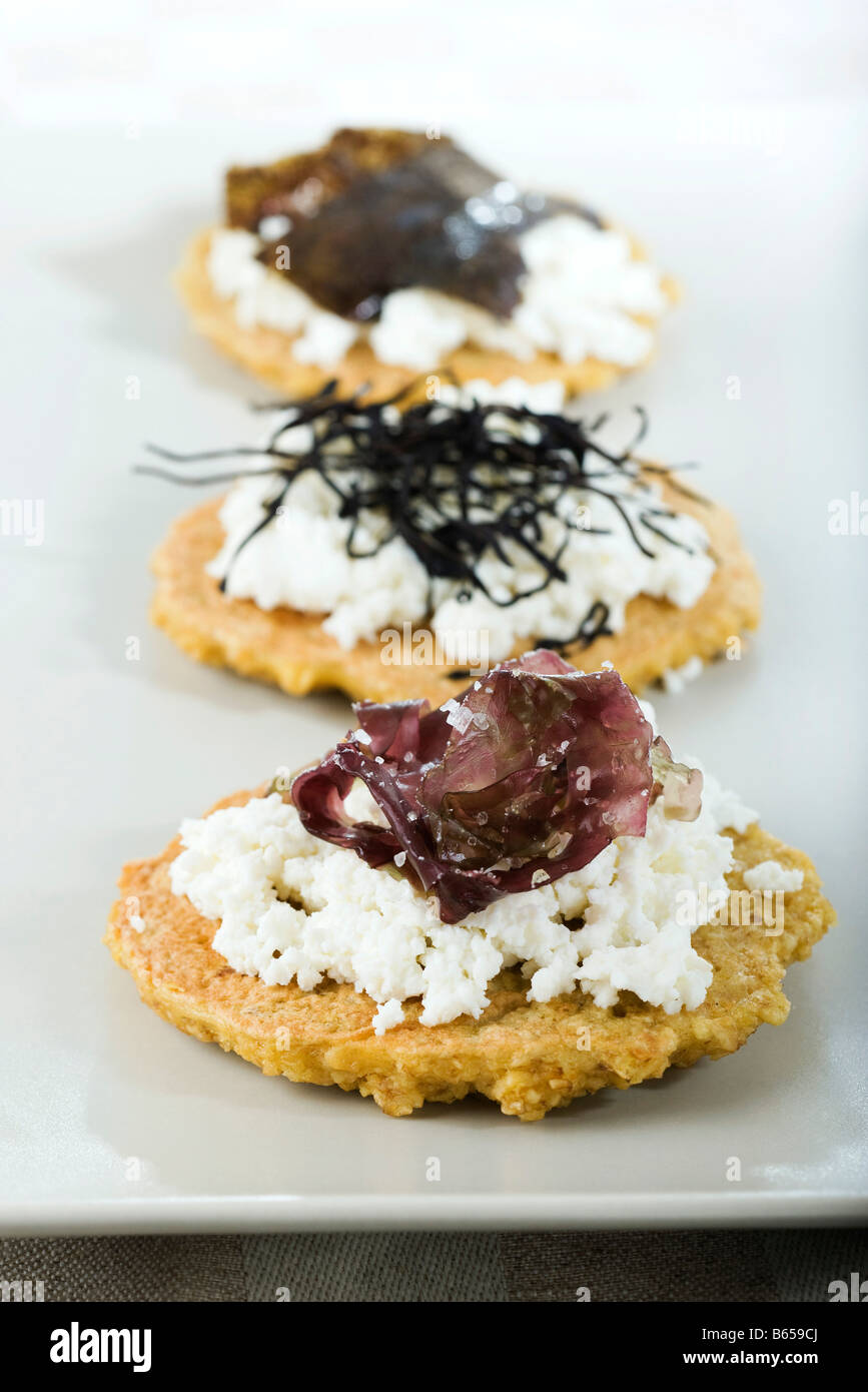 Vegetable fritters topped with feta cheese and seaweed Stock Photo